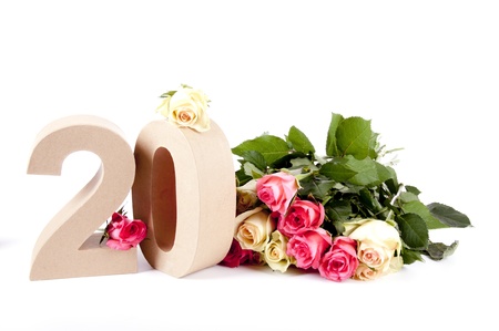 Number of age in a colorful studiosetting,surrounded with rosesの写真素材