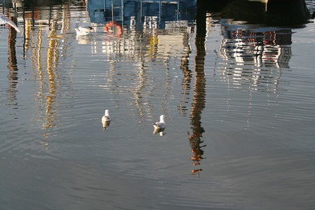 Netherlands, Bruinisse, july 2016: reflections of fishingboats in the harbourのeditorial素材