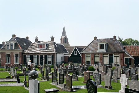 Netherlands, Hallum,-june 2016: Grave-yard surrounded by village housesのeditorial素材