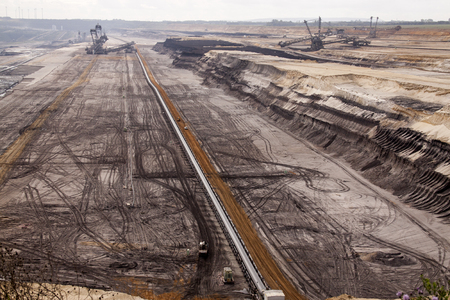 Germany, North Rhine Westphalia, -june 2017:  ground excavator in action moving mullock and soil at open pit coal mine; Germany,for winning brown coalの写真素材