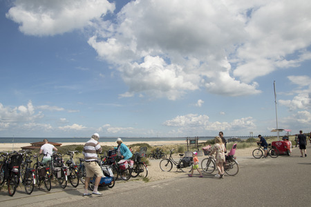 Veerse Meer,northsea beach august 2017: On top of the dune biciyles from the beach visitors are stalledのeditorial素材