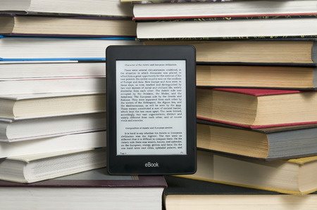 Electronic book shown versus several regular text books
