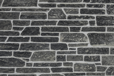 Ancient stone wall texture with irregular shapesの写真素材