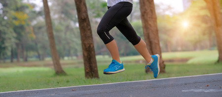 young fitness woman legs walking in the park outdoor, female runner running on the road outside,...