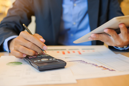 Businessman using tablet for analysis maketing plan, Accountant calculate financial report, computer with graph chart.  Business, Finance and Technology conceptsの写真素材