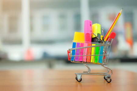 Back to school and Education concepts with shopping cart, pencil, highlighter and notepadの写真素材