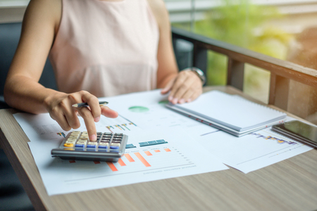 Businesswoman analysis maketing plan, Accountant calculate financial report, with graph chart.  Business, Finance and Accounting conceptsの写真素材