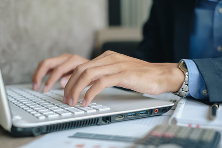 Businessman using laptop for analysis maketing plan, Manager calculate financial report and graph chart.  Business, Finance and Accounting conceptsの写真素材