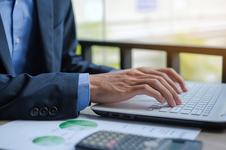Businessman using laptop for analysis maketing plan, Manager calculate financial report and graph chart.  Business, Finance and Accounting conceptsの写真素材