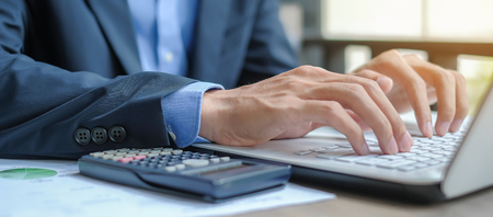Businessman using laptop for analysis maketing plan, Manager calculate financial report and graph chart.  Business, Finance and Accounting conceptsの写真素材