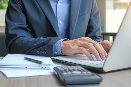 Businessman using laptop for analysis maketing plan, Manager calculate financial report and graph chart.  Business, Finance and Accounting conceptsの写真素材