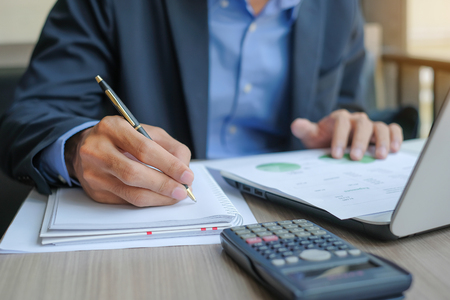 Businessman analysis maketing plan, Manager calculate financial report and graph chart.  Business, Finance and Accounting conceptsの写真素材