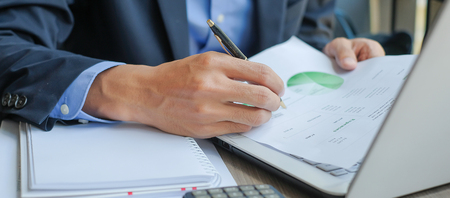 Businessman analysis maketing plan, Manager calculate financial report and graph chart.  Business, Finance and Accounting conceptsの写真素材