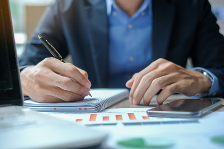 Businessman using smatphone for analysis maketing plan, Manager calculate financial report and graph chart.  Business, Finance and Accounting conceptsの写真素材