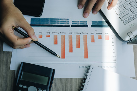 Businesswoman analysis maketing plan, Manager calculate financial report and graph chart.  Business, Finance and Accounting conceptsの写真素材
