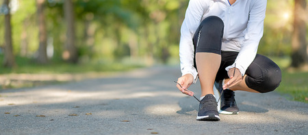 young fitness woman legs walking in the park outdoor, female runner running on the road outside,...