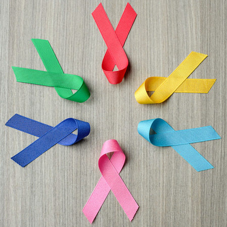 World cancer day (February 4). colorful awareness ribbons; blue, red, green, pink and yellow color...