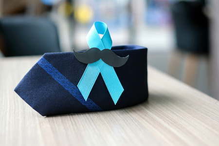 Prostate Cancer Awareness, light Blue Ribbon with mustache and necktie for supporting people living and illness. Men Healthcare and World cancer day conceptの写真素材