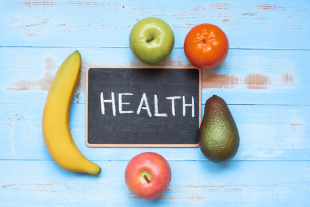 banana, apple avocado and orange with chalkboard on blue  wooden background. Healthcare and healthy food concept, Top view and Copy space for your textの写真素材