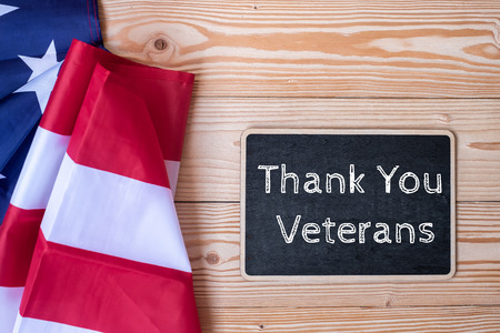 Thank You Veterans text written in chalkboard with  flag of the United States of America on wooden background. USA holiday of Veterans, Memorial, Independence and Labor Dayの写真素材
