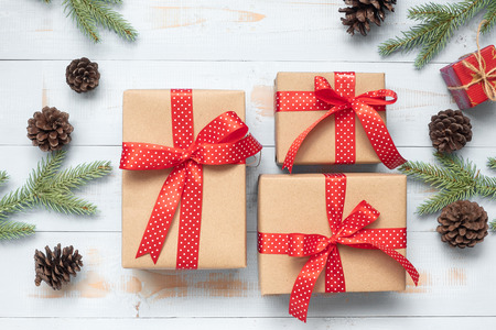 Christmas decoration, gift box and pine tree branches on wooden background, preparation for holiday concept, Happy New Year and Xmas Holidays. Top view and Copy Space for textの写真素材