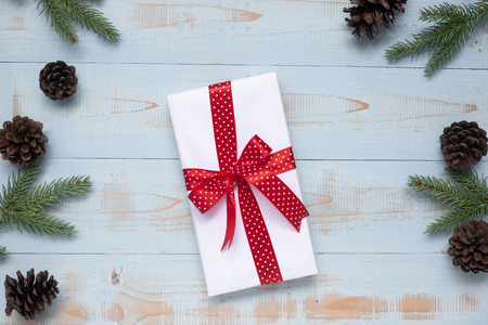 Christmas decoration, gift box and pine tree branches on wooden background, preparation for holiday concept, Happy New Year and Xmas Holidays. Top view and Copy Space for textの写真素材