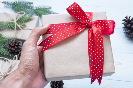 Christmas decoration, gift box and pine tree branches on wooden background, preparation for holiday concept, Happy New Year and Xmas Holidays. Top view and Copy Space for textの写真素材