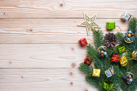 Christmas background with decoration, gift box, Star shape, Bell and pine tree branches on wooden board, Happy New Year and Xmas Holidays banner. Top view and Copy Space for your textの写真素材