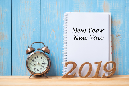 2019 Happy New year New You Text on notebook, retro alarm clock and wooden number  on table and copy space. Resolution, Goals and Mission Conceptの写真素材