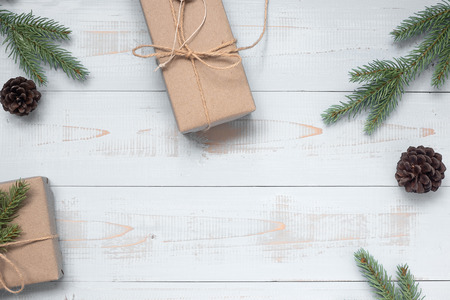 Christmas decoration, gift box and pine tree branches on wooden background, preparation for holiday concept, Happy New Year and Xmas Holidays. Top view and Copy Space for textの写真素材