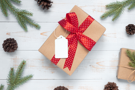 Christmas decoration, gift box and pine tree branches on wooden background, preparation for holiday concept, Happy New Year and Xmas Holidays. Top view and Copy Space for textの写真素材