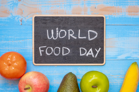 green apple, red apple, Avocado, orange, banana and grape on blue wooden background. World Food Day Concept (October 16), Top view and Copy space for your textの写真素材