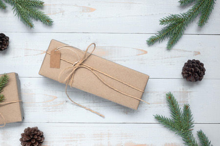 Christmas decoration, gift box and pine tree branches on wooden background, preparation for holiday concept, Happy New Year and Xmas Holidays. Top view and Copy Space for textの写真素材