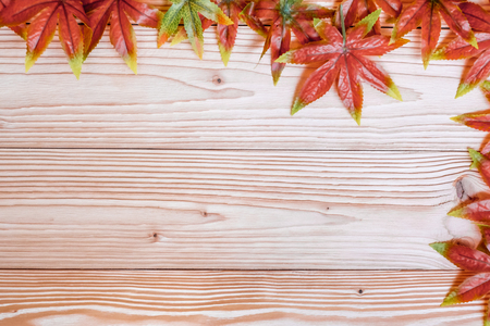 Autumn Maple leaves on wooden background. Top view and Copy space for your textの写真素材