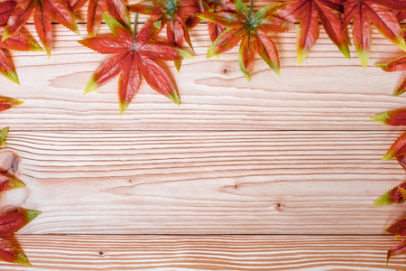 Autumn Maple leaves on wooden background. Top view and Copy space for your textの写真素材