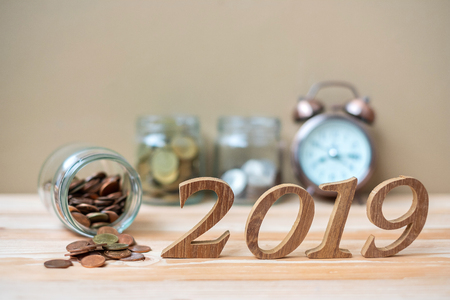 2019 Happy New Year with gold coins stack and wooden number on table. business, investment, retirement planning, finance, Saving and New Year Resolution conceptsの写真素材