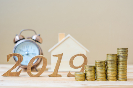 2019 Happy New Year with gold coins stack and wooden number on table. business, investment, retirement planning, finance, Saving and New Year Resolution conceptsの写真素材