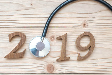2019 Happy New Year for healthcare, Wellness and medical concept. Stethoscope with wooden number on table backgroundの写真素材
