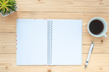 notebook, black coffee cup, pen and glasses on table, Top view and copy space. Goals, Target, Solution, Strategy and Mission conceptの写真素材