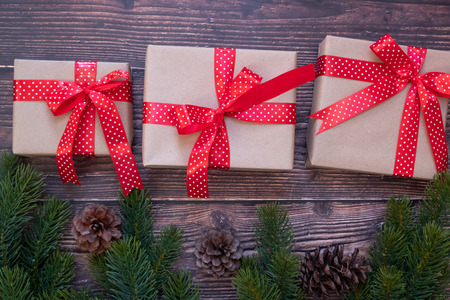 Christmas decoration, gift box and pine tree branches on wooden background, preparation for holiday concept, Happy New Year and Xmas Holidays. Top view and Copy Space for textの写真素材