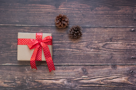 Christmas decoration, gift box and pine tree branches on wooden background, preparation for holiday concept, Happy New Year and Xmas Holidays. Top view and Copy Space for textの写真素材
