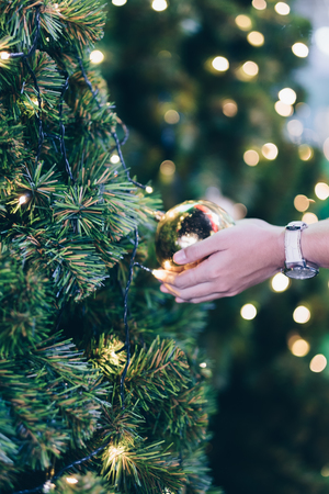 woman hand holding Christmas decoration, gift box and pine tree branches, Happy New Year and Xmas Holidaysの写真素材