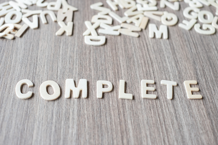 COMPLETE word of wooden alphabet letters. Business and Idea conceptの写真素材