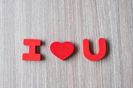 I Love U word of wooden alphabet letters with red heart shape on table background. Romance, Romantic and Valentineâs day conceptsの写真素材