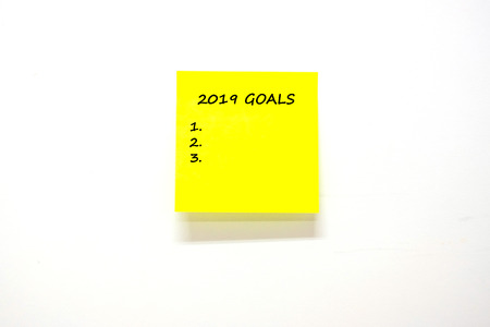 2019 Goals text with stick note paper or note on white background. reminder and business conceptの写真素材
