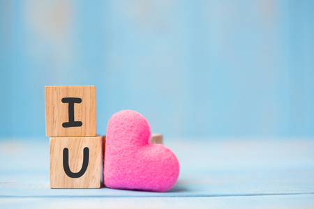 I LOVE U wooden cubes with pink heart shape decoration on blue table background and copy space for text. Love, Romantic and Happy Valentineâs day holiday conceptの写真素材