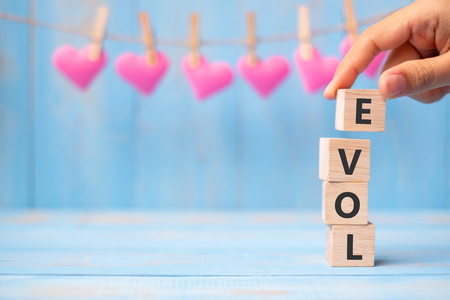 LOVE wooden cubes with pink heart shape decoration on blue table background and copy space for text. Love, Romantic and Happy Valentineâs day holiday conceptの写真素材