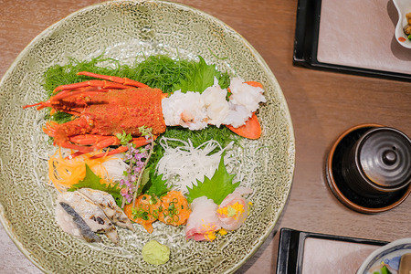Japanese Dinner set; lobster, fish and appetizer on wooden table in Traditional ryokan resort at Kawaguchiko lake, Yamanashi, Japanの写真素材