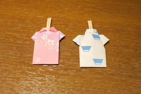 couple tootpick inside Japanese paper Kimono shape with pink cherry blossome and fuji moutain on wooden table in dinner room, Traditional ryokan resort at Kawaguchiko lake, Yamanashi, Japanの写真素材