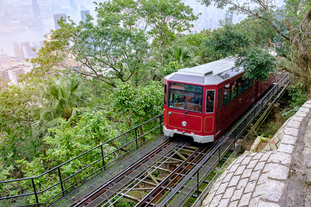 Victoria Peak Tram and unidentified people with Hong Kong city skyline background. landmark and destination for tourist attractions in HKの写真素材